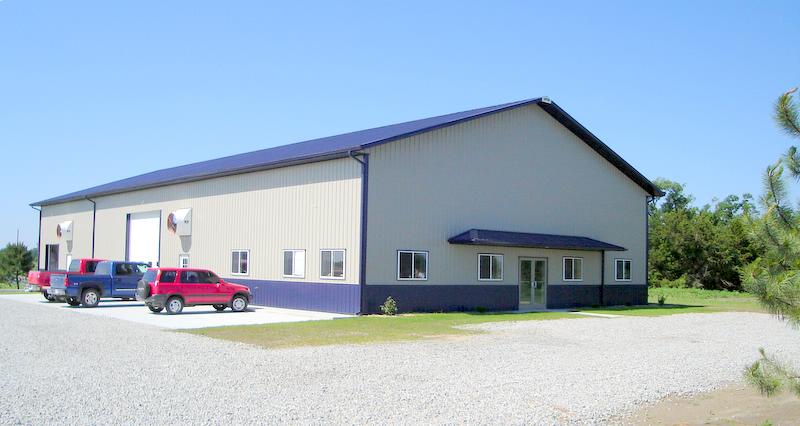 A clean shop air environment with an industrial air purifier near a parked car.