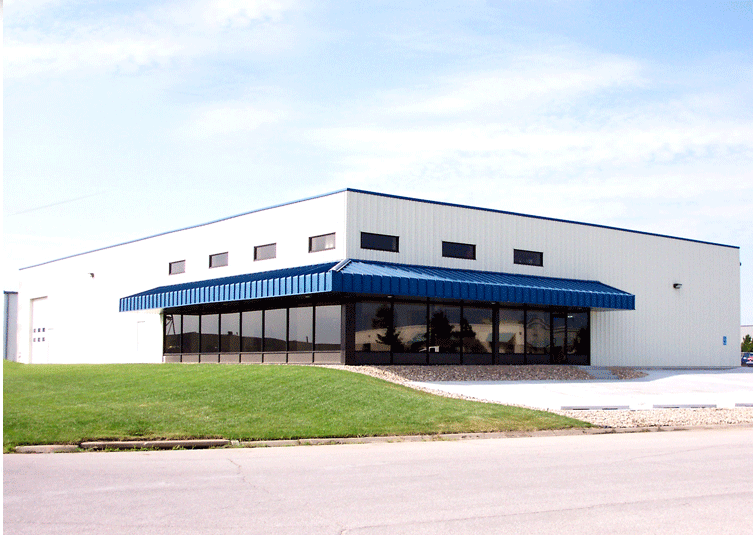 A blue awning adorns a white building, with an industrial air purifier ensuring clean air inside.