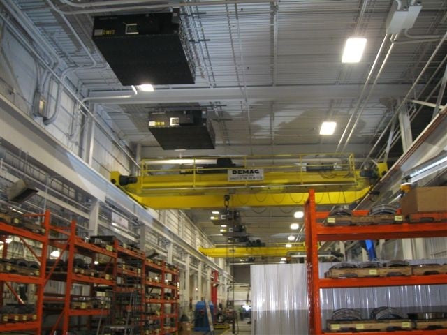 A warehouse with clean air and a large overhead crane.