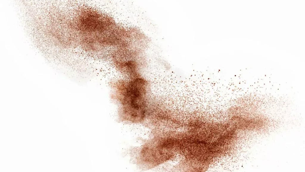 An image of a brown powder on a white background, with clean air.