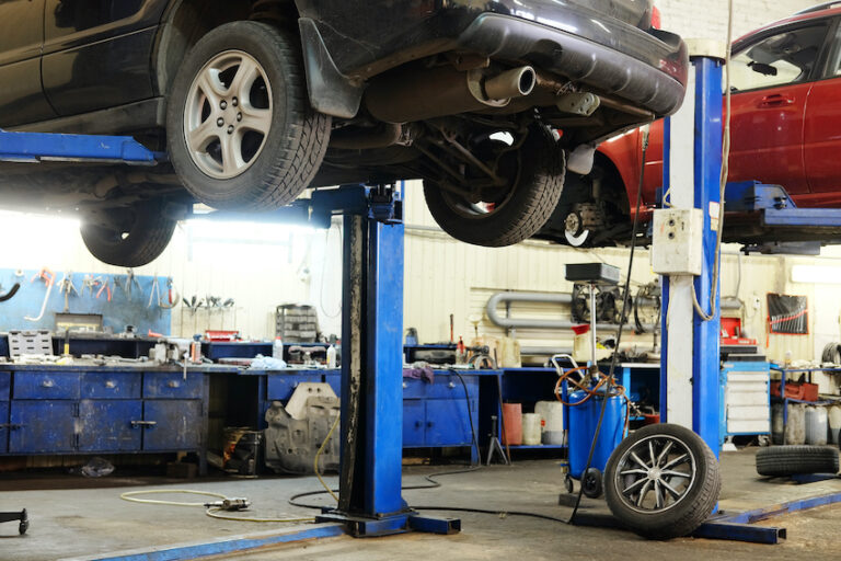 A car being lifted in a garage with clean air.