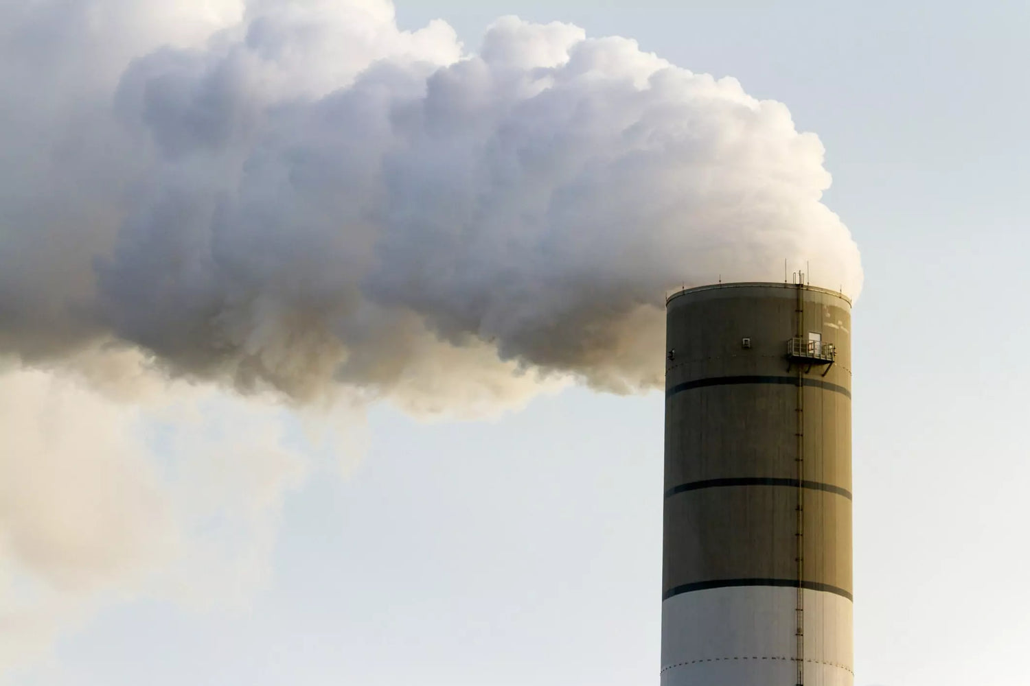 An industrial smokestack emitting clean air.